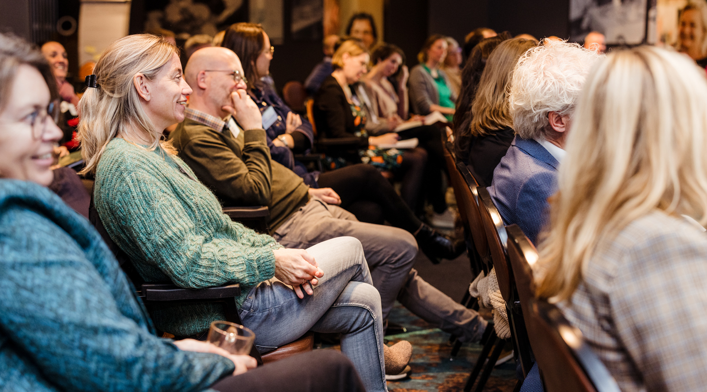 Publiek luistert enthousiast tijdens congres