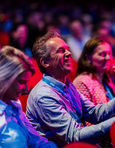publiek in theaterzaal bij Dimpact-congres 2025